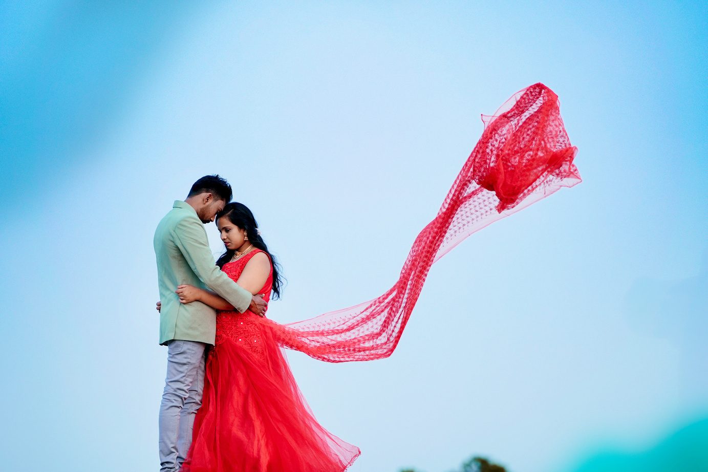 Pre-wedding couple portrait with flowing red dress